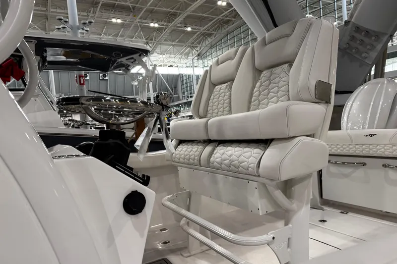 Slide: The Image of 2026 Tidewater 256 CC Adventure boat interior with modern seating and rod holders. - 9