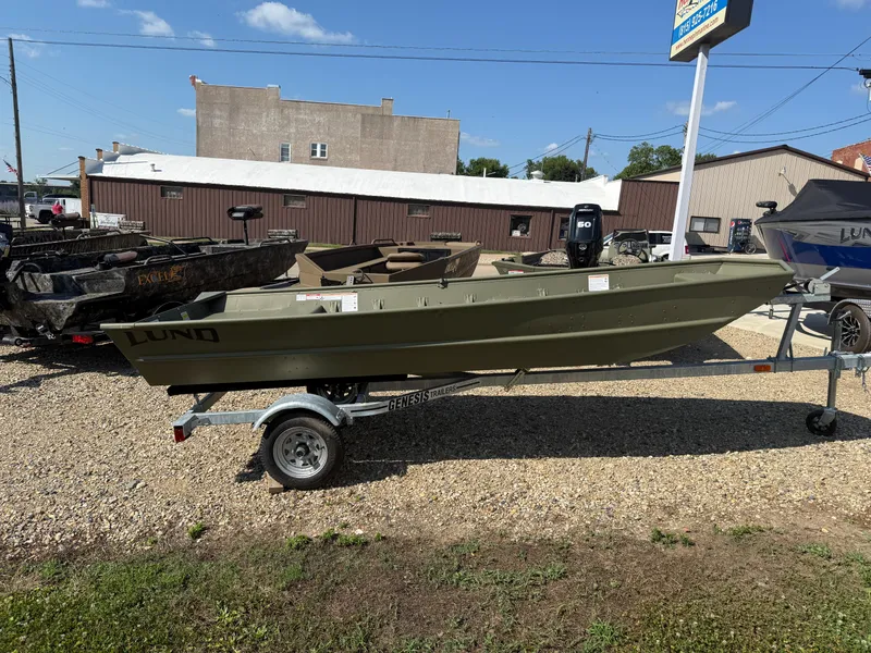 Slide: The Image of 2025 Lund 1440M boat on trailer in outdoor dealership lot. - 0