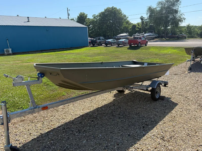 Slide: The Image of 2025 Lund 1440M boat on trailer in outdoor setting. - 2