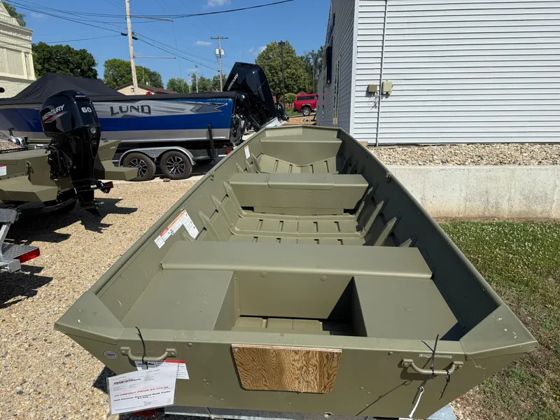 Slide: The Image of 2025 Lund 1440M boat displayed outdoors, featuring a durable, open design. - 4