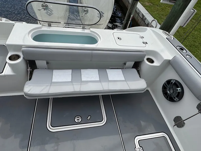 Slide: The Image of 2020 Sea Pro 259 Center Console boat interior with seating and storage compartments. - 19