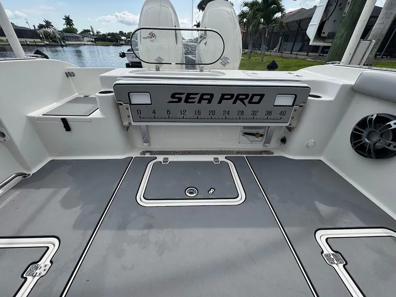 Slide: The Image of 2020 Sea Pro 259 Center Console boat deck with storage compartments and ruler. - 20