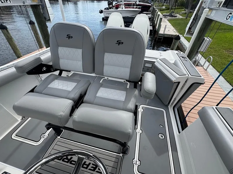 Slide: The Image of 2020 Sea Pro 259 Center Console boat with dual cushioned seats and sleek design. - 21