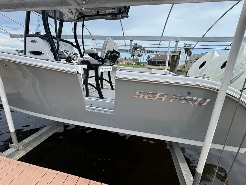 Slide: The Image of 2020 Sea Pro 259 Center Console boat on lift, side view. - 31