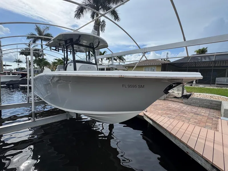 Slide: The Image of 2020 Sea Pro 259 Center Console boat docked near palm trees and water. - 33