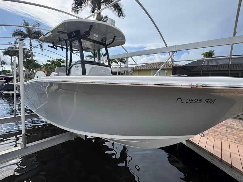 Slide: The Image of 2020 Sea Pro 259 Center Console boat docked, side view with registration number FL 9595 SM. - 38