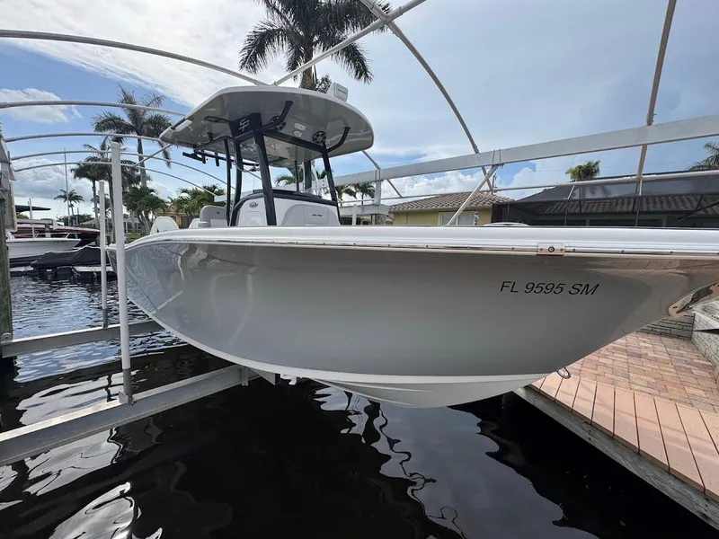 Slide: The Image of 2020 Sea Pro 259 Center Console boat docked, with palm trees in the background. - 39