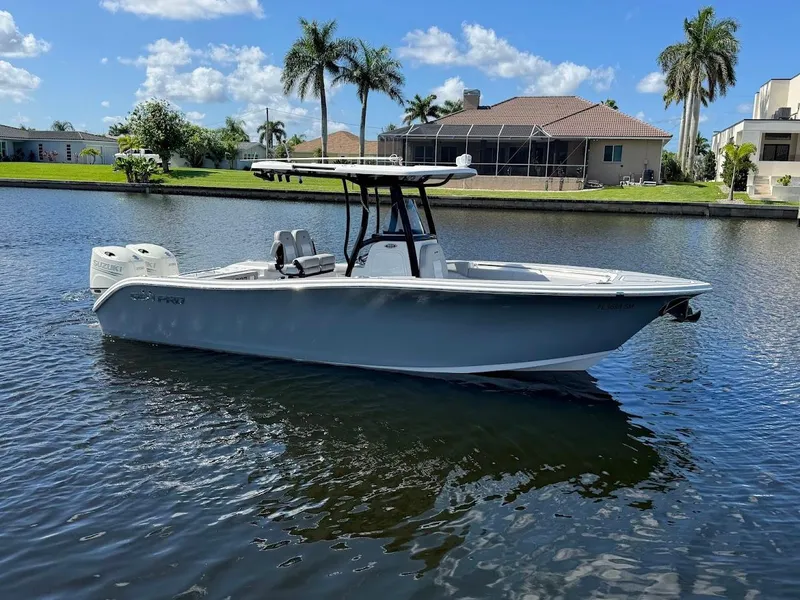 Slide: The Image of 2020 Sea Pro 259 Center Console boat on a sunny canal with palm trees. - 7