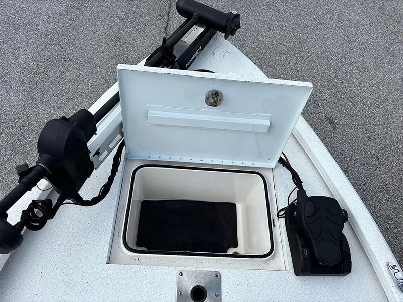 Slide: The Image of 2022 Vexus AVX1980CC boat with open storage compartment and trolling motor. - 14