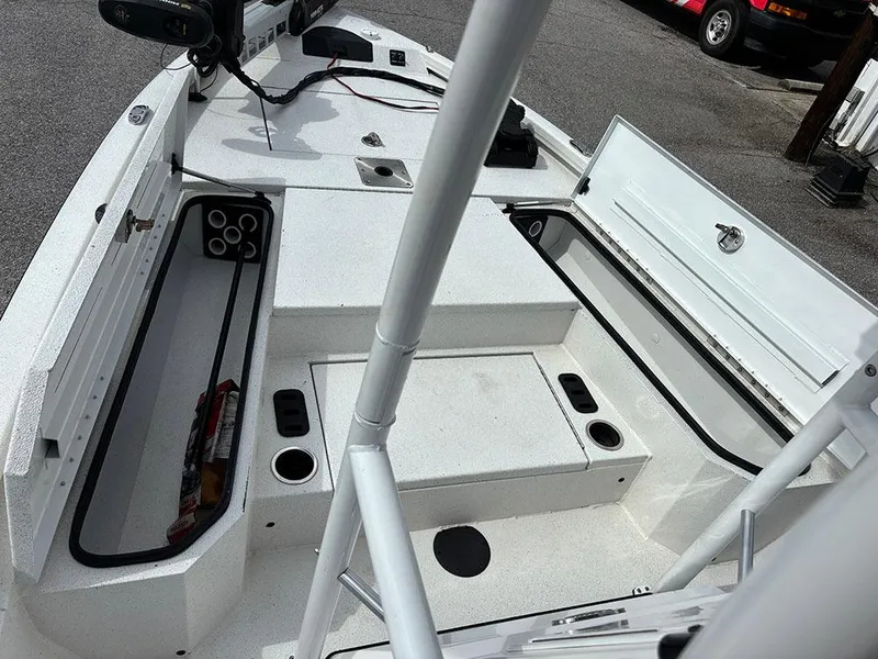 Slide: The Image of 2022 Vexus AVX1980CC boat interior with open storage compartments and fishing rod holders. - 16
