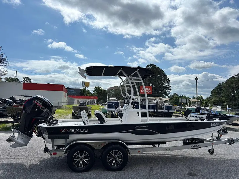 Slide: The Image of 2022 Vexus AVX1980CC boat on trailer under cloudy sky at dealership. - 5