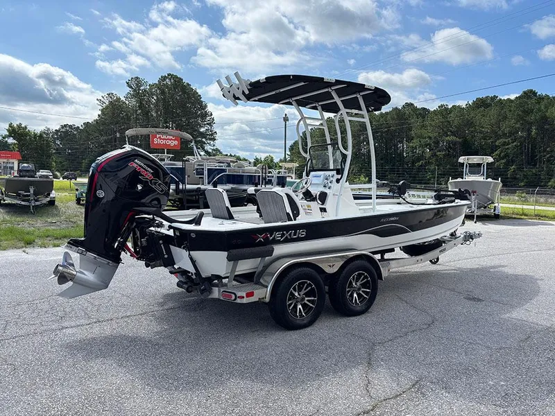 Slide: The Image of 2022 Vexus AVX1980CC boat on trailer, parked outdoors under cloudy sky. - 6