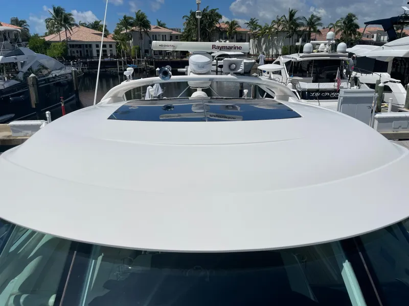Slide: The Image of 2010 Sea Ray 540 Sundancer yacht docked at marina with clear sky and palm trees. - 10