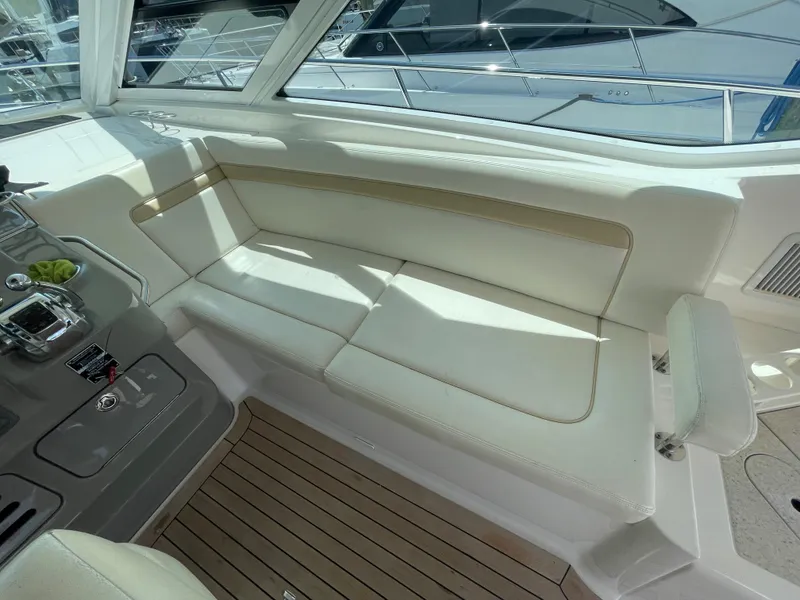 Slide: The Image of 2010 Sea Ray 540 Sundancer interior with white seating and wooden flooring. - 16