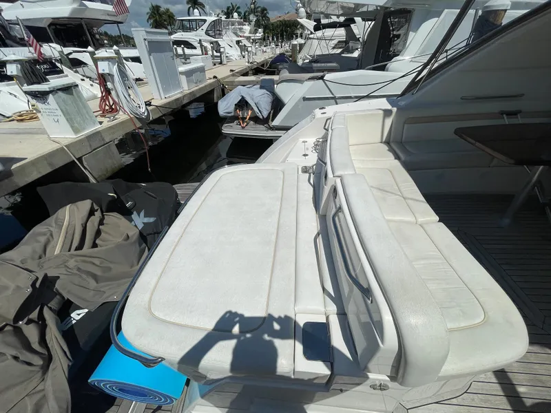 Slide: The Image of 2010 Sea Ray 540 Sundancer yacht with white seating at a marina. - 19