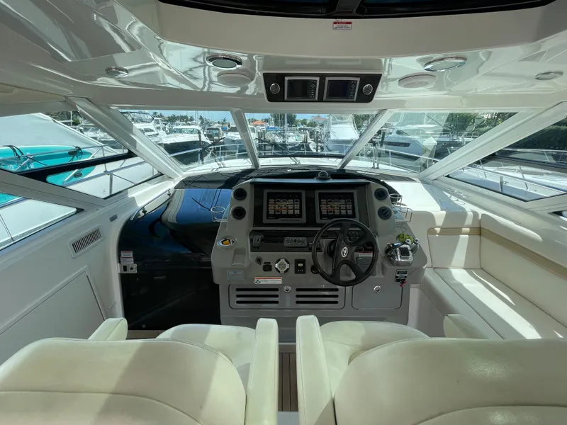 Slide: The Image of Interior view of 2010 Sea Ray 540 Sundancer yacht cockpit with modern controls and seating. - 20
