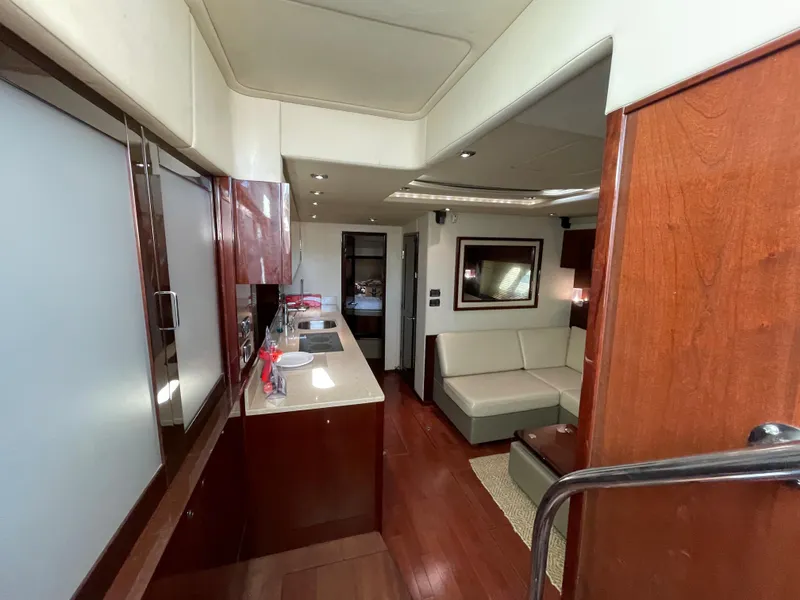 Slide: The Image of Luxurious interior of 2010 Sea Ray 540 Sundancer yacht with modern kitchen and seating area. - 24