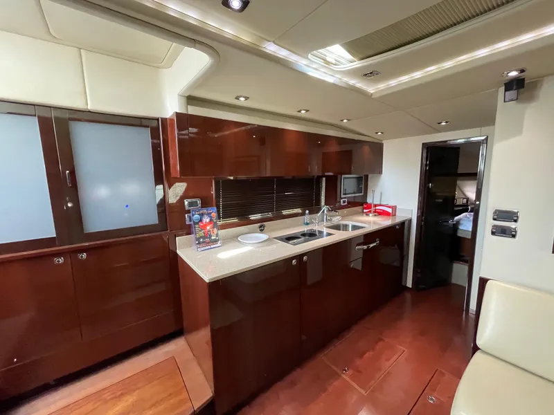 Slide: The Image of Luxurious kitchen interior of 2010 Sea Ray 540 Sundancer yacht with modern amenities. - 26
