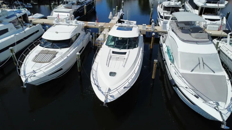 Slide: The Image of 2010 Sea Ray 540 Sundancer yacht docked among other boats in a marina. - 3