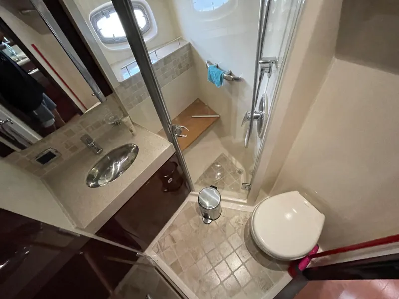 Slide: The Image of Bathroom interior of 2010 Sea Ray 540 Sundancer yacht, featuring shower, sink, and toilet. - 31