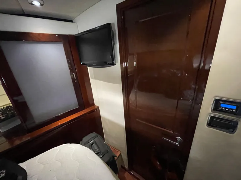 Slide: The Image of Interior cabin of 2010 Sea Ray 540 Sundancer with TV and wooden door. - 34