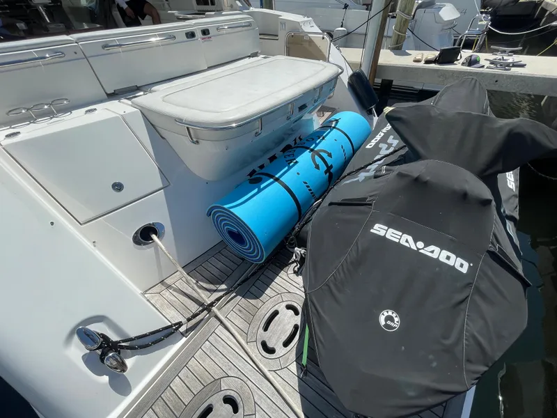 Slide: The Image of 2010 Sea Ray 540 Sundancer yacht with Sea-Doo jet skis and blue mat on deck. - 37