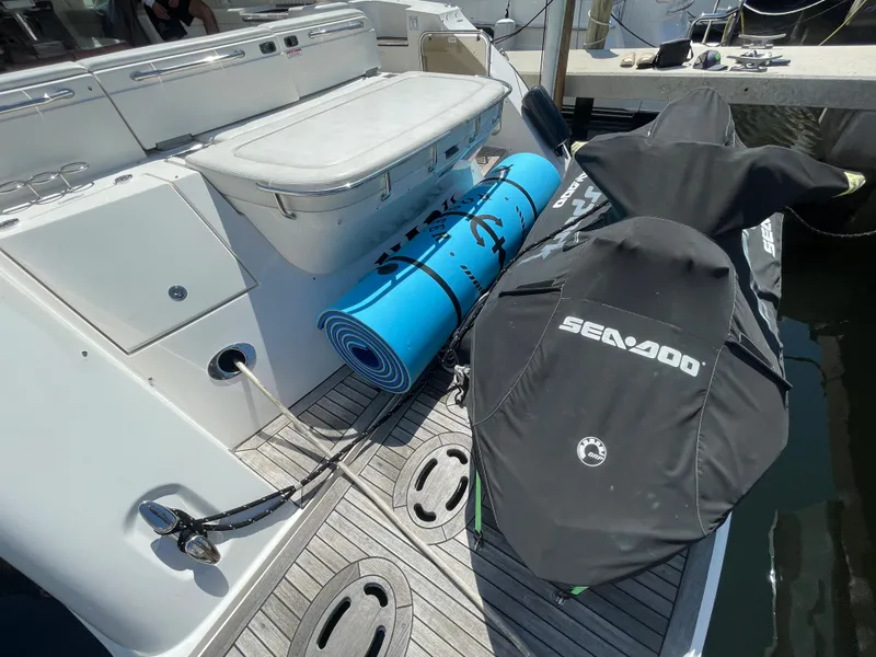 Slide: The Image of 2010 Sea Ray 540 Sundancer yacht deck with Sea-Doo cover and blue mat. - 38