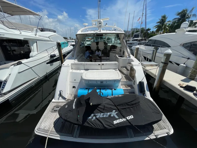 Slide: The Image of 2010 Sea Ray 540 Sundancer yacht docked with jet ski on deck. - 39