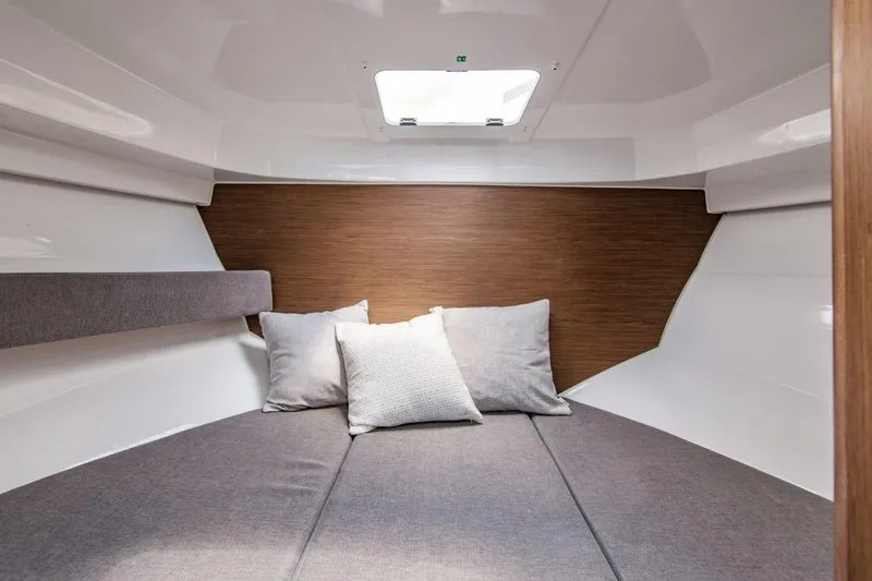 Slide: The Image of 2025 Beneteau Antares 8 cabin interior with cozy bedding and modern design. - 7