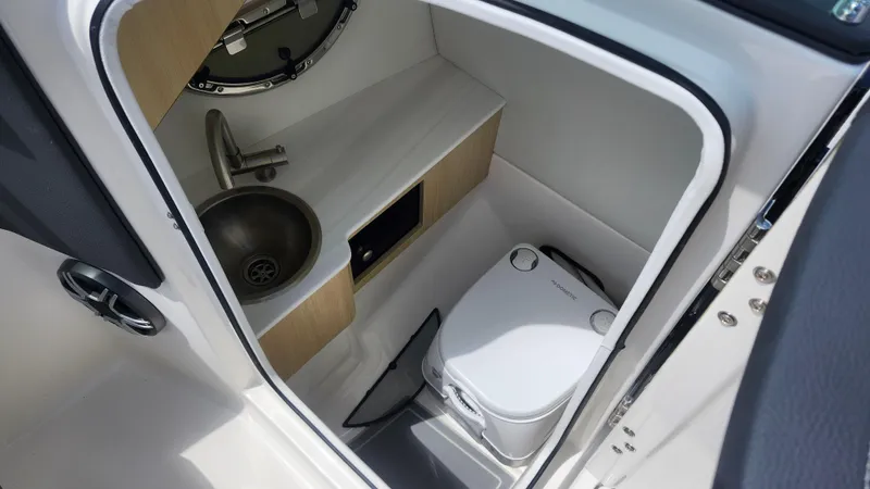 Slide: The Image of Compact bathroom in 2026 Regal LX4 boat with sink and portable toilet. - 11