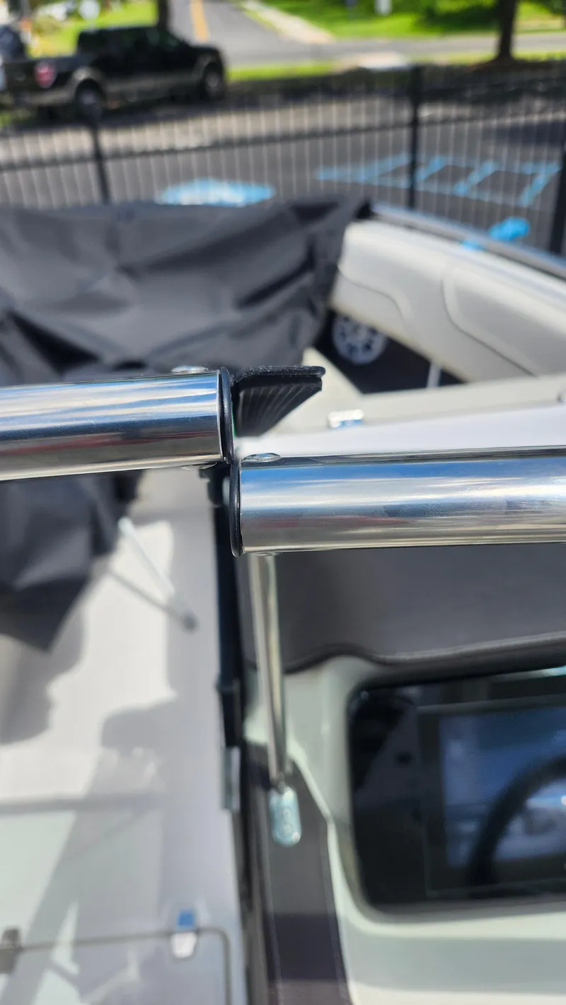 Slide: The Image of 2026 Regal LX4 boat on trailer in a marina setting. - 2