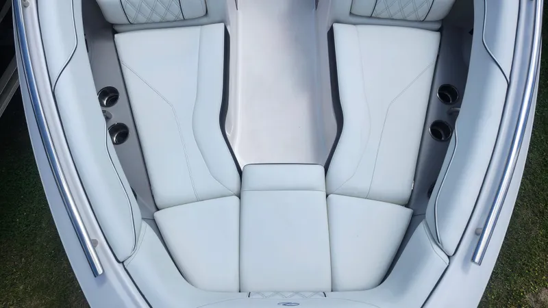 Slide: The Image of Luxurious seating in 2026 Regal LX4 boat, featuring sleek white upholstery and cup holders. - 4