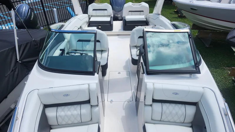 Slide: The Image of 2026 Regal LX4 boat interior with white seating and dual windshields. - 5