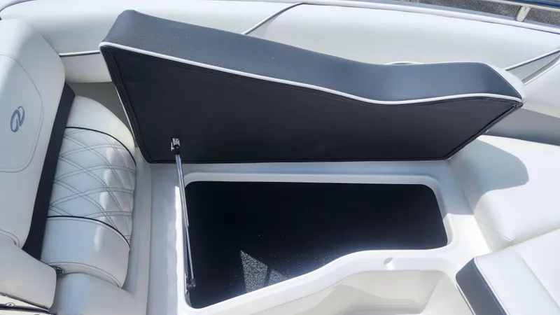 Slide: The Image of Open storage compartment in 2026 Regal LX4 boat with cushioned seating. - 7