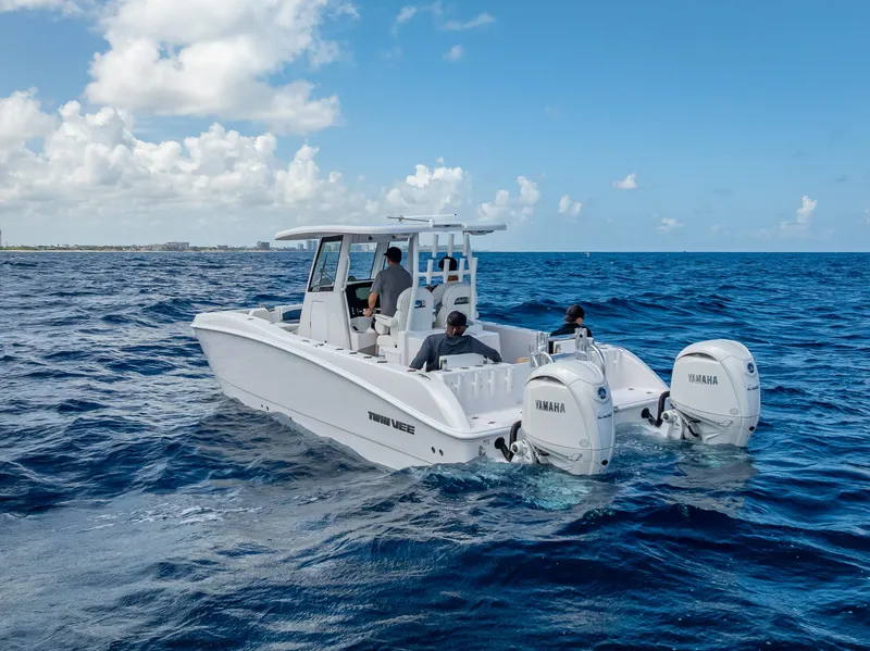 Slide: The Image of 2026 Twin Vee 260 GFX2 CC cruising on open ocean under clear skies. - 12