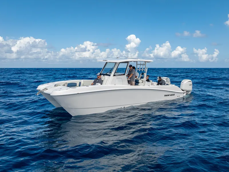 Slide: The Image of 2026 Twin Vee 260 GFX2 CC boat cruising on open ocean with Yamaha engines. - 13