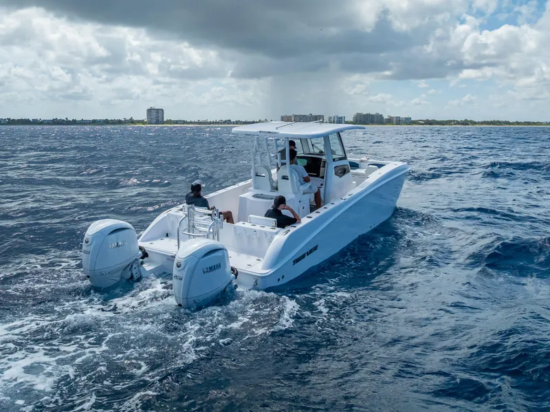 Slide: The Image of 2026 Twin Vee 260 GFX2 CC boat cruising on open water under cloudy sky. - 19