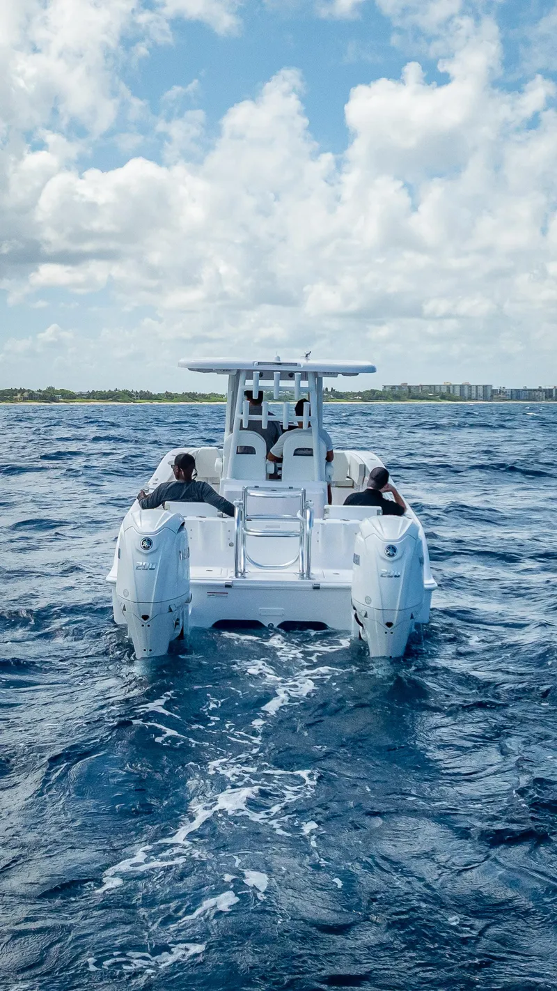 Slide: The Image of 2026 Twin Vee 260 GFX2 CC boat cruising on open water under a cloudy sky. - 21