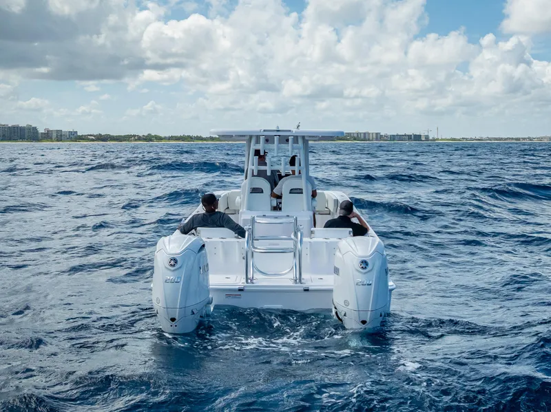 Slide: The Image of 2026 Twin Vee 260 GFX2 CC boat cruising on open water under cloudy sky. - 22