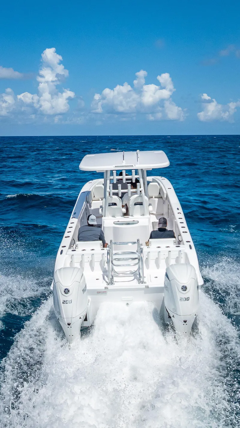 Slide: The Image of 2026 Twin Vee 260 GFX2 CC cruising on open ocean under clear blue sky. - 23