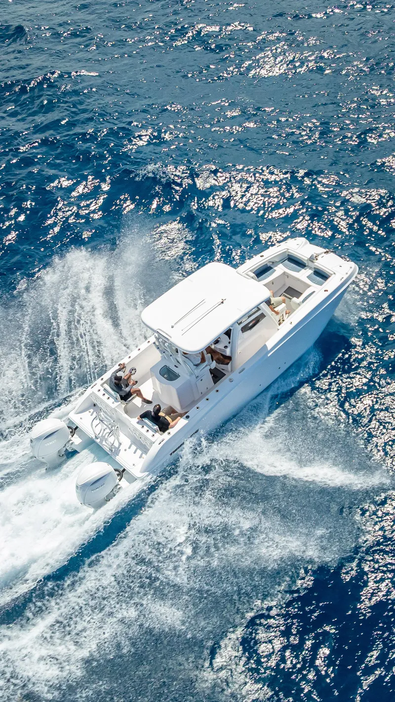 Slide: The Image of Aerial view of 2026 Twin Vee 260 GFX2 CC boat cruising on blue ocean waters. - 25