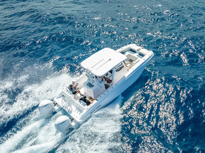 Slide: The Image of 2026 Twin Vee 260 GFX2 CC cruising on open blue ocean waters. - 26