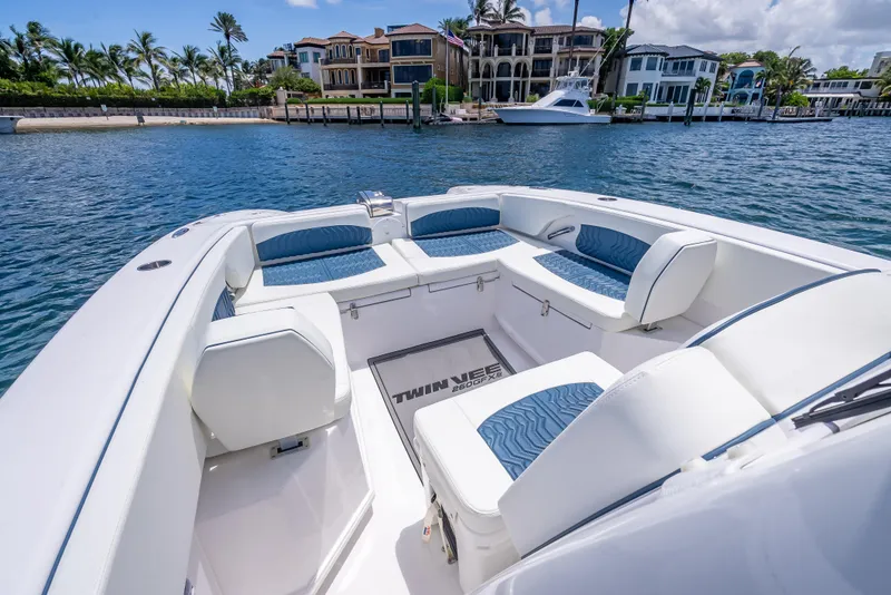 Slide: The Image of 2026 Twin Vee 260 GFX2 CC boat interior with luxurious seating, dockside view. - 28