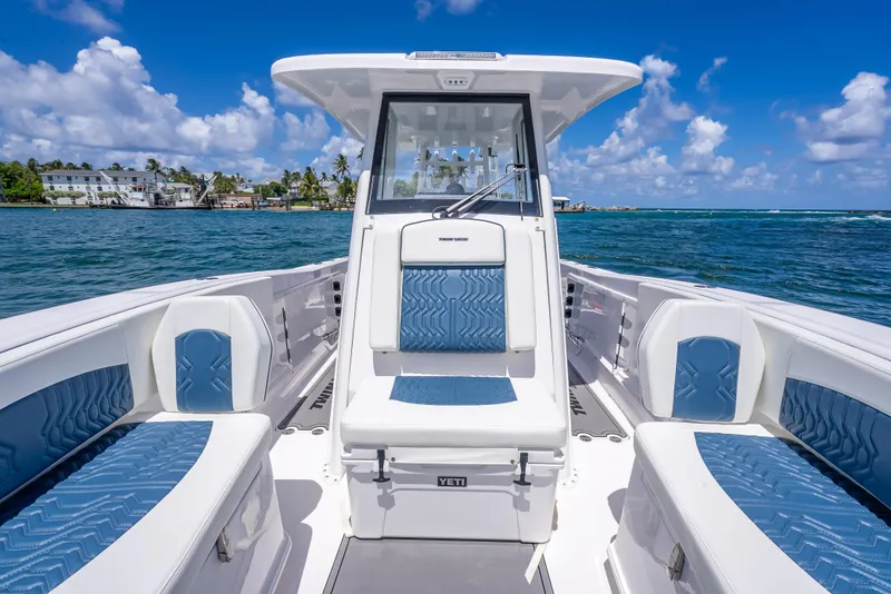 Slide: The Image of 2026 Twin Vee 260 GFX2 CC boat interior with blue seating, ocean view, and clear sky. - 32