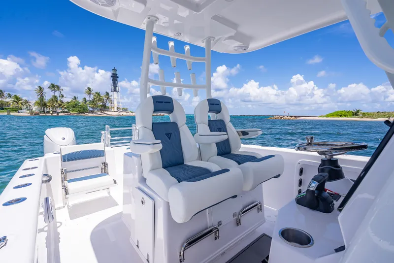 Slide: The Image of 2026 Twin Vee 260 GFX2 CC boat interior with ocean view and lighthouse in background. - 36