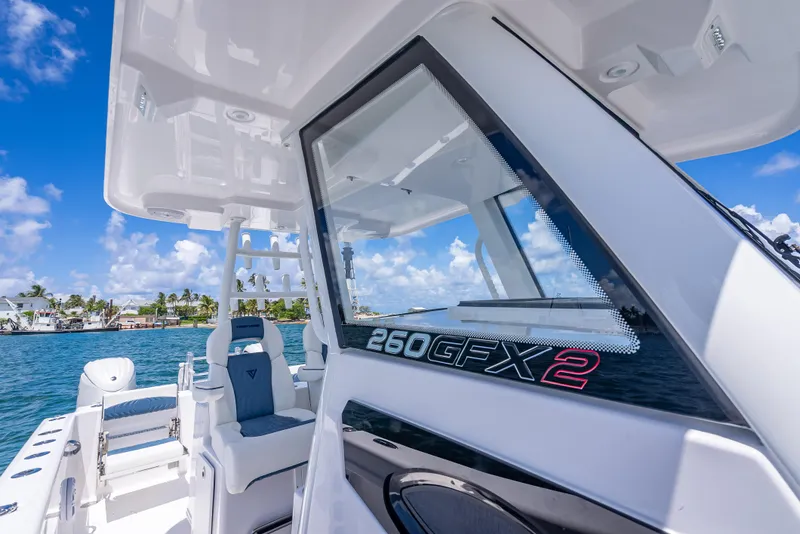 Slide: The Image of 2026 Twin Vee 260 GFX2 CC boat on water, showcasing sleek design and modern features. - 38