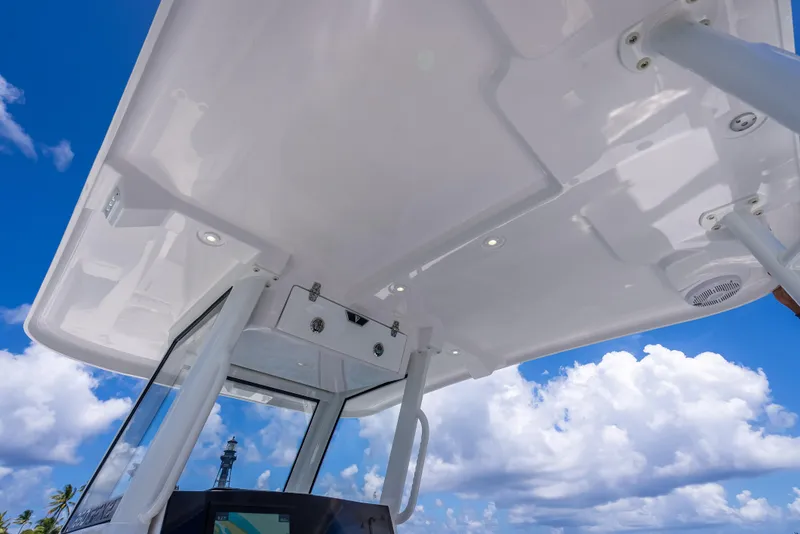 Slide: The Image of 2026 Twin Vee 260 GFX2 CC boat canopy against blue sky and clouds. - 46