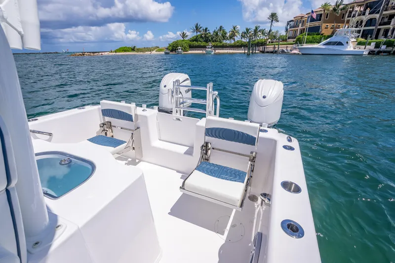 Slide: The Image of 2026 Twin Vee 260 GFX2 CC boat on water, featuring comfortable seating and scenic coastal view. - 48