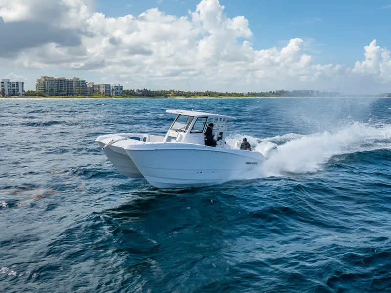 Slide: The Image of 2026 Twin Vee 260 GFX2 CC cruising on open ocean under clear skies. - 8