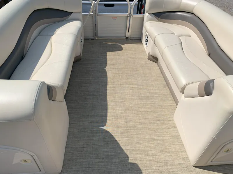 Slide: The Image of 2007 Sun Tracker Party Barge 22 interior with beige seating and carpet flooring. - 5